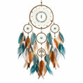Attrape-rêves artisanal avec plumes turquoise et marron